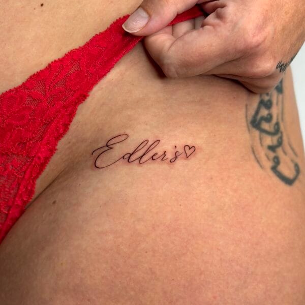 Delicate Cursive Script Hip Tattoo