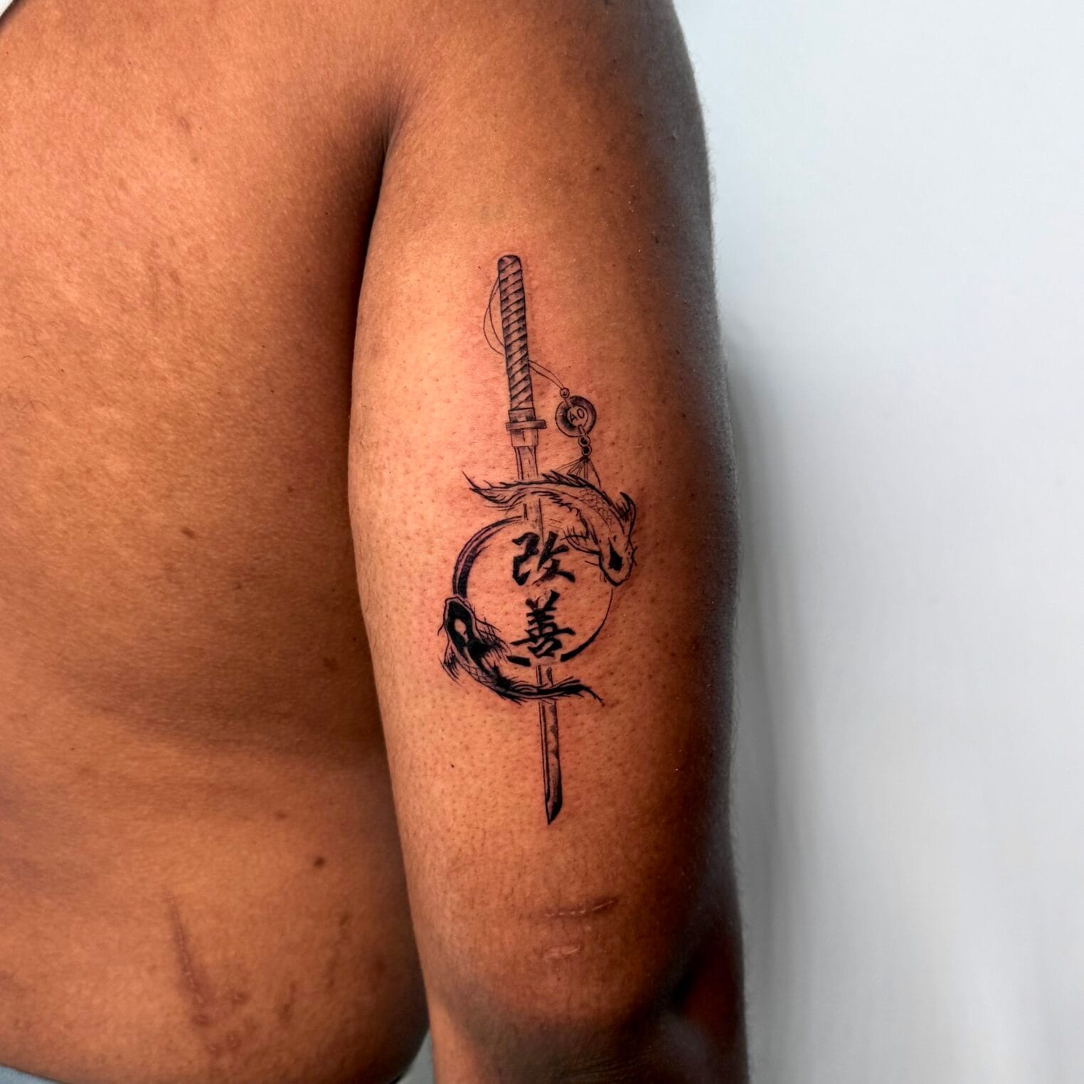 Japanese Katana And Koi Tattoo With Kaizen Kanji On Upper Arm