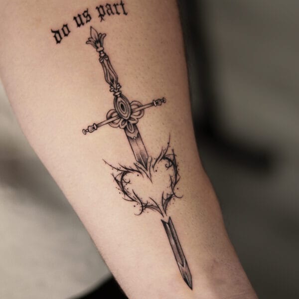 Ornamental Sword And Heart Tattoo On Forearm
