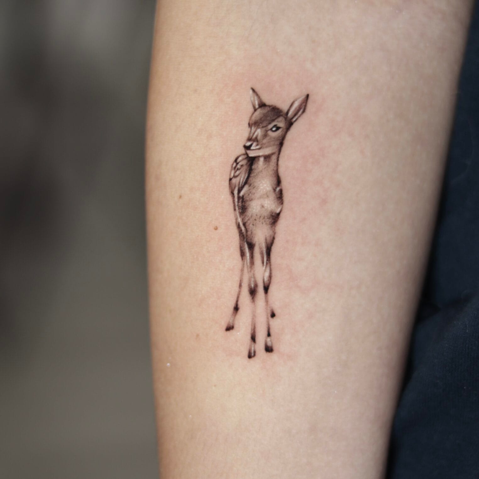 Small Realistic Baby Deer Arm Tattoo In Black And Gray